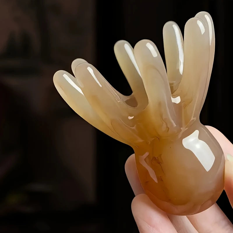 Zuzu Aura brown octopus scalp massager with smooth rounded tips held in hand