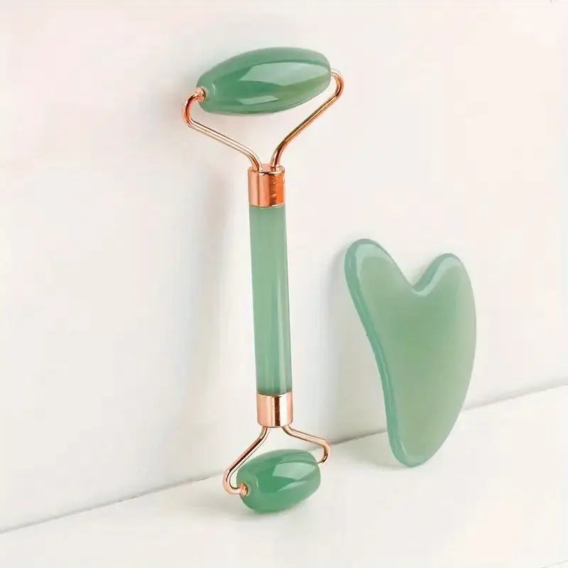 Green jade roller and gua sha stone from Zuzu Aura skincare tools for glowing skin set