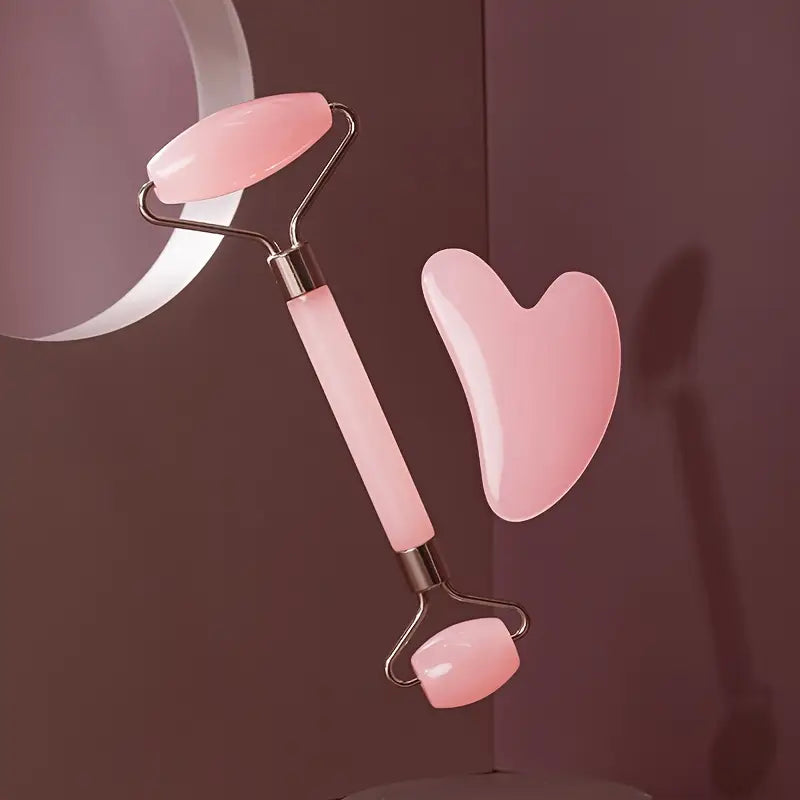 Zuzu Aura pink jade roller and gua sha skincare tools for glowing skin on brown background