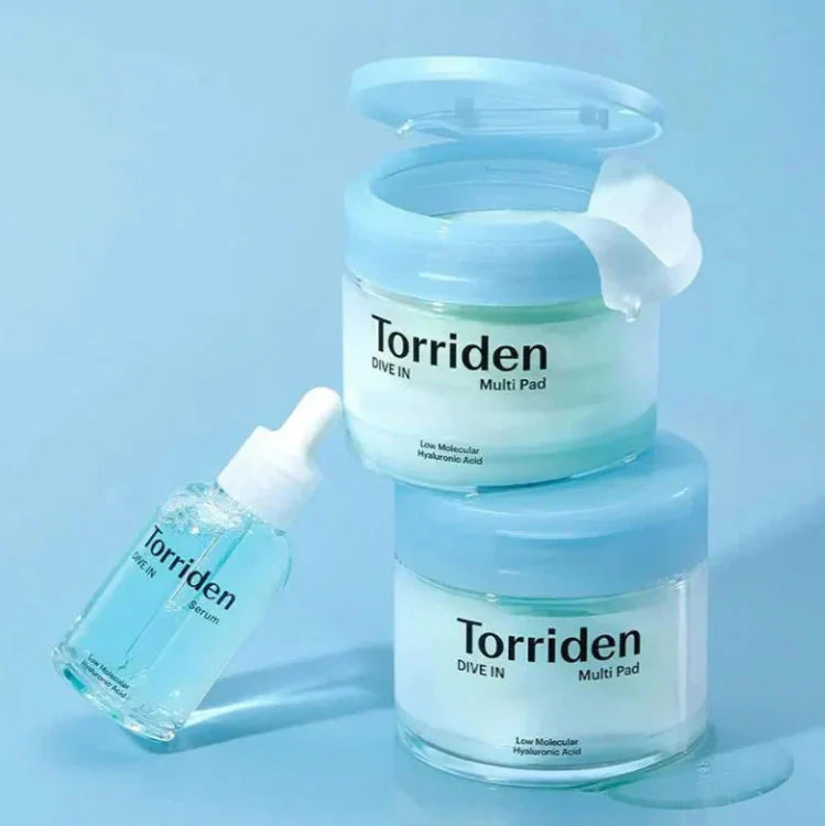 Torriden hyaluronic acid face pads for hydration with blue lids and accompanying serum bottle on a blue background