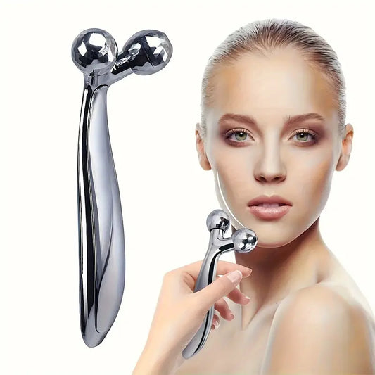 Zuzu Aura 3D face massage roller metallic tool held by woman for facial skincare