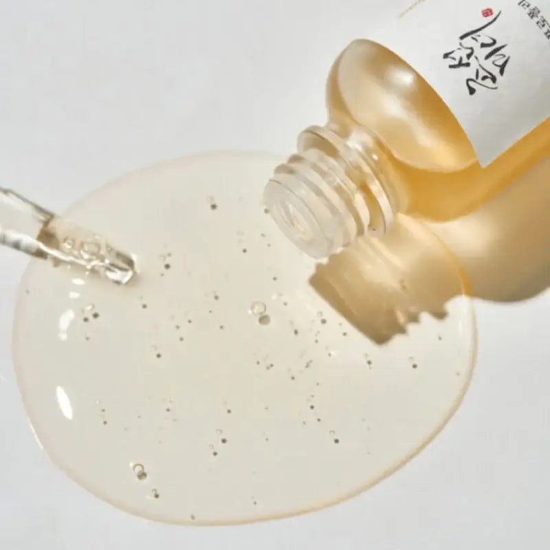 Beauty Of Joseon Propolis Niacinamide Serum with a pipette and serum droplet on a surface