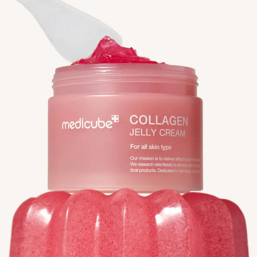 Medicube collagen jelly cream in a pink jar with a spatula for smooth application on all skin types