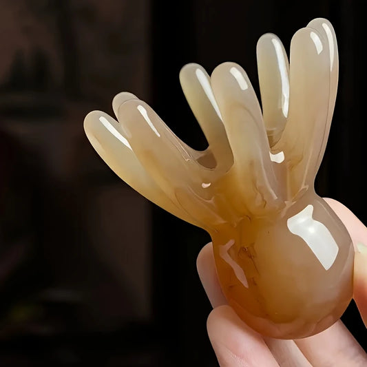 Zuzu Aura brown octopus scalp massager with smooth rounded tips held in hand