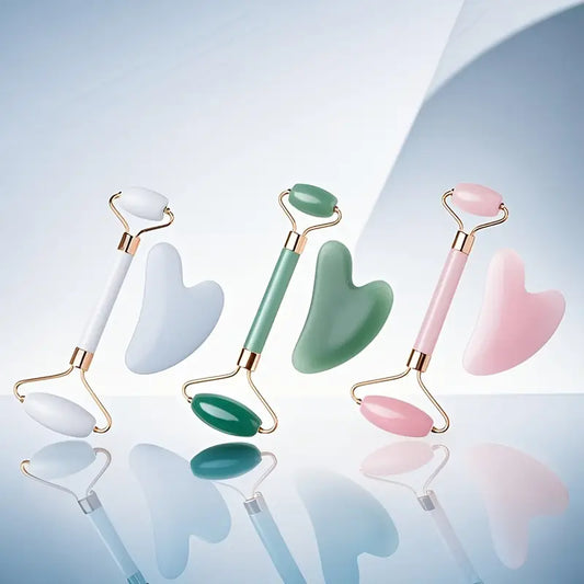 Zuzu Aura skincare tools for glowing skin featuring white, green, and pink jade rollers with matching gua sha stones