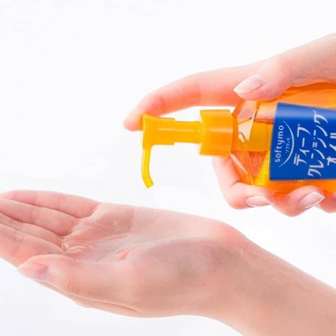 Zuzu Aura Makeup Remover shown in a hand with a pump for easy application and effective cleansing