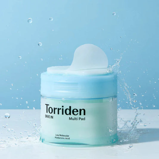 Torriden hyaluronic acid face pads for hydration in a clear blue jar with water splash background
